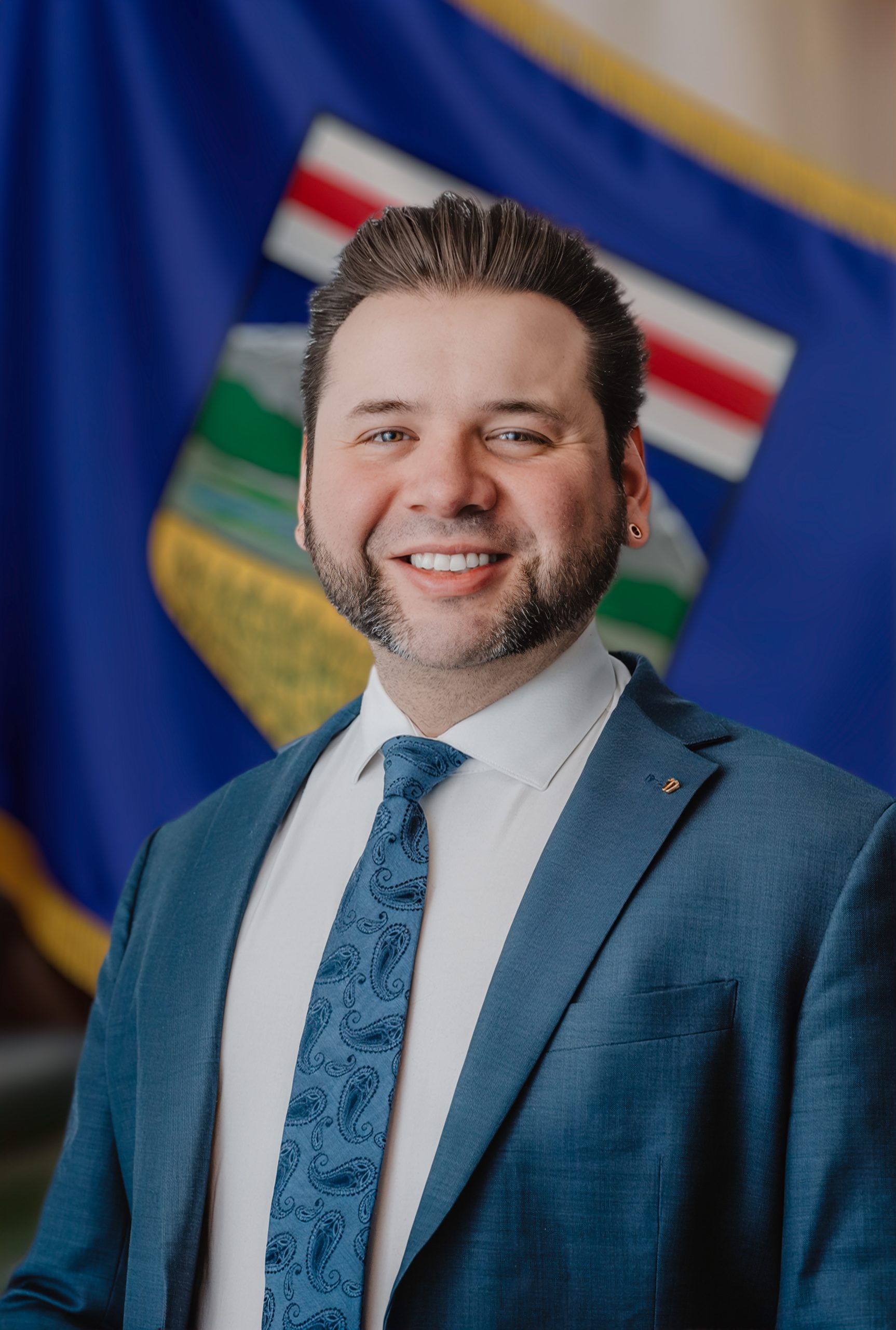Ray Donnelly – UCP Nomination Candidate Portrait Portrait of Ray Donnelly, UCP nomination candidate, standing in front of the Alberta provincial flag